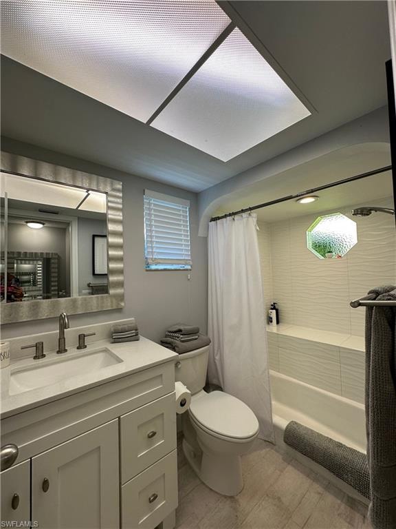 Full bathroom with shower / bath combo with shower curtain, toilet, and vanity