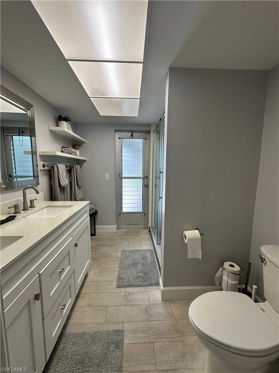 Bathroom featuring vanity, toilet, and a healthy amount of sunlight