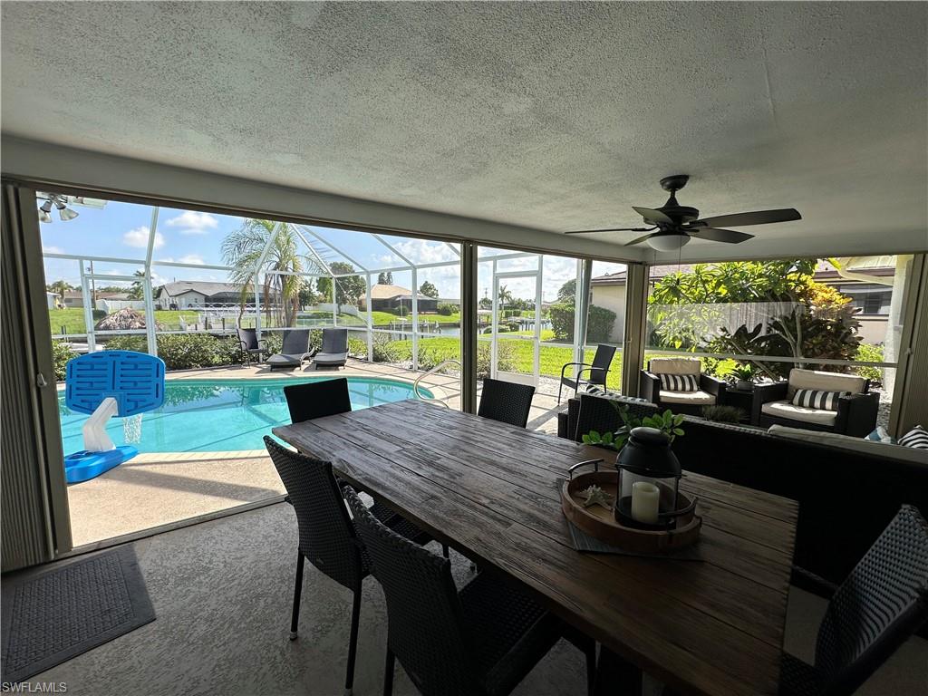 Sunroom with a healthy amount of sunlight and ceiling fan