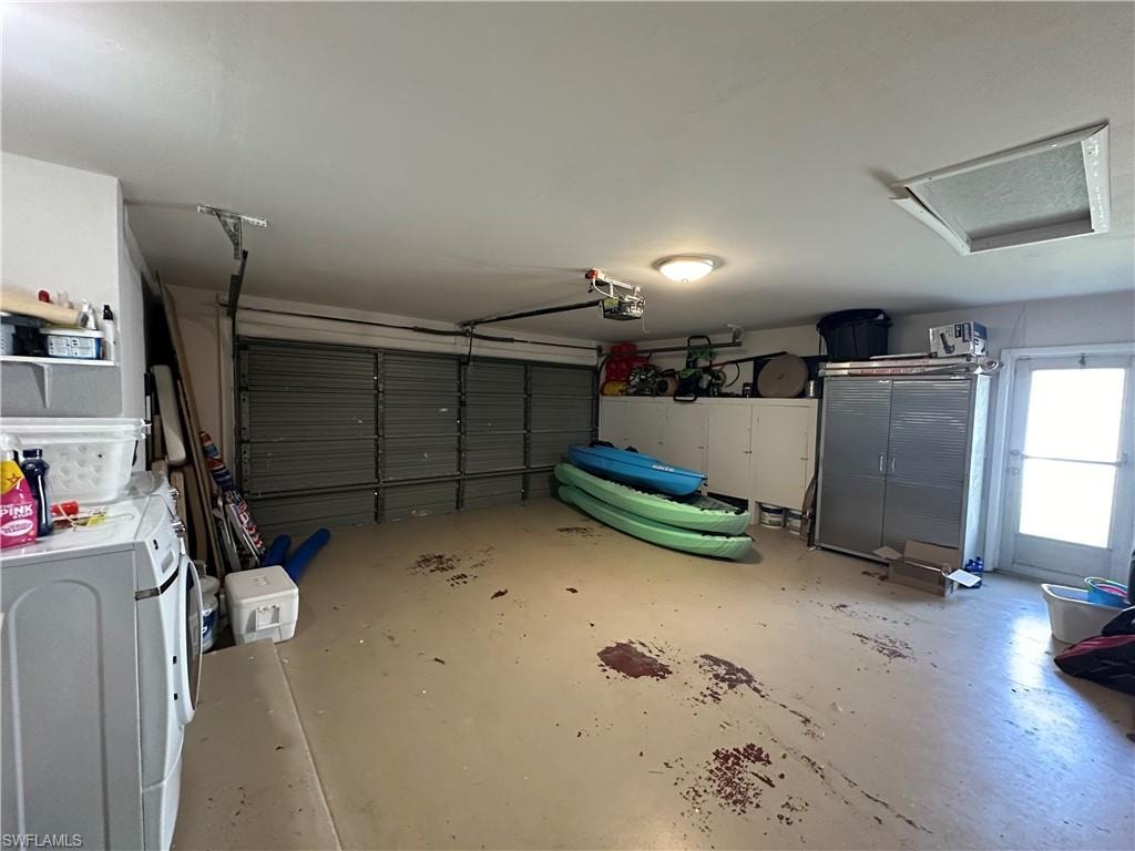 Garage featuring washer / dryer and a garage door opener
