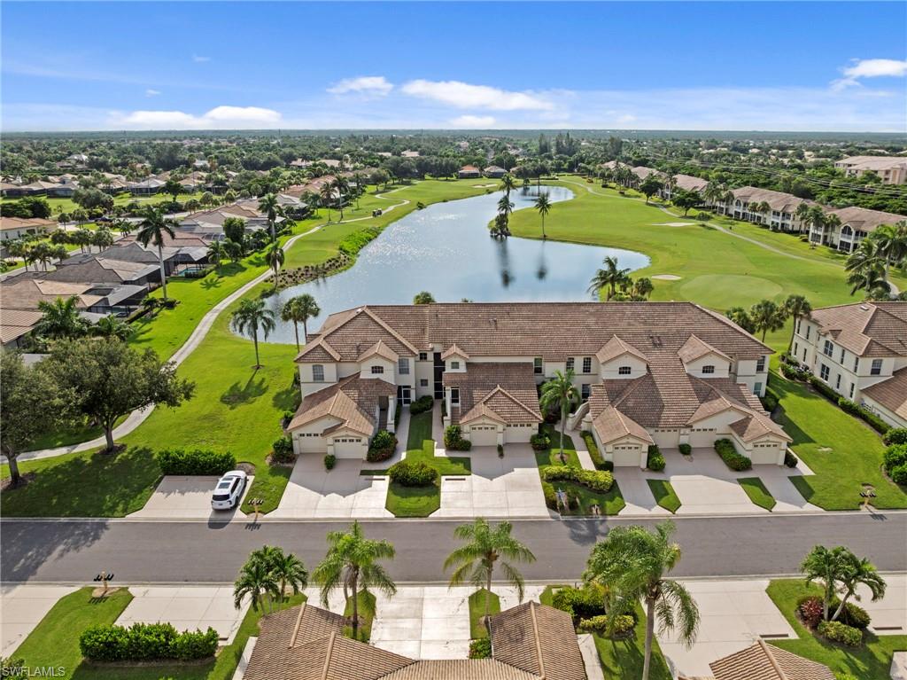 Elegant Mediterranean-style residence featuring a clay tile roof, arched architectural details, and a stucco exterior