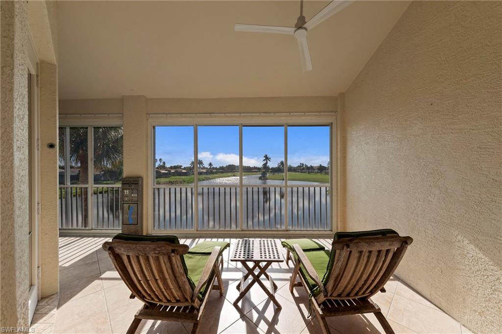 Screened patio with tiled flooring and a ceiling fan