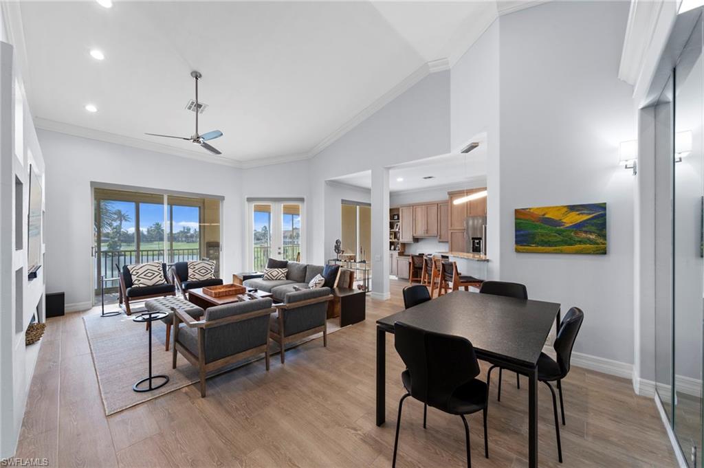 Open-concept living space featuring wood-finish flooring, recessed ceiling lighting, and a ceiling fan