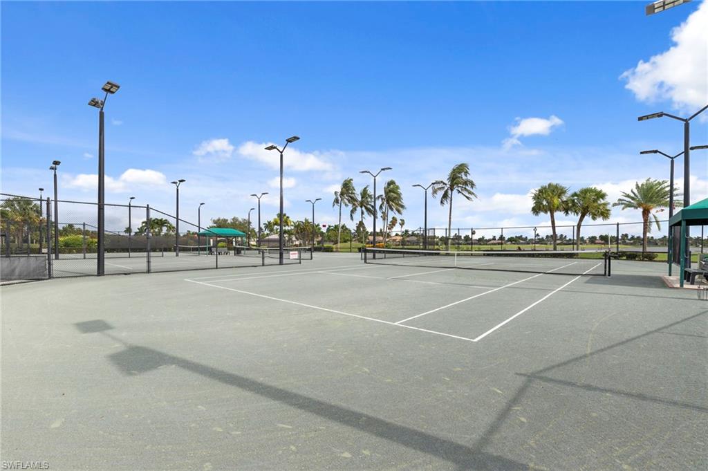 Multiple tennis courts featuring a hard court surface