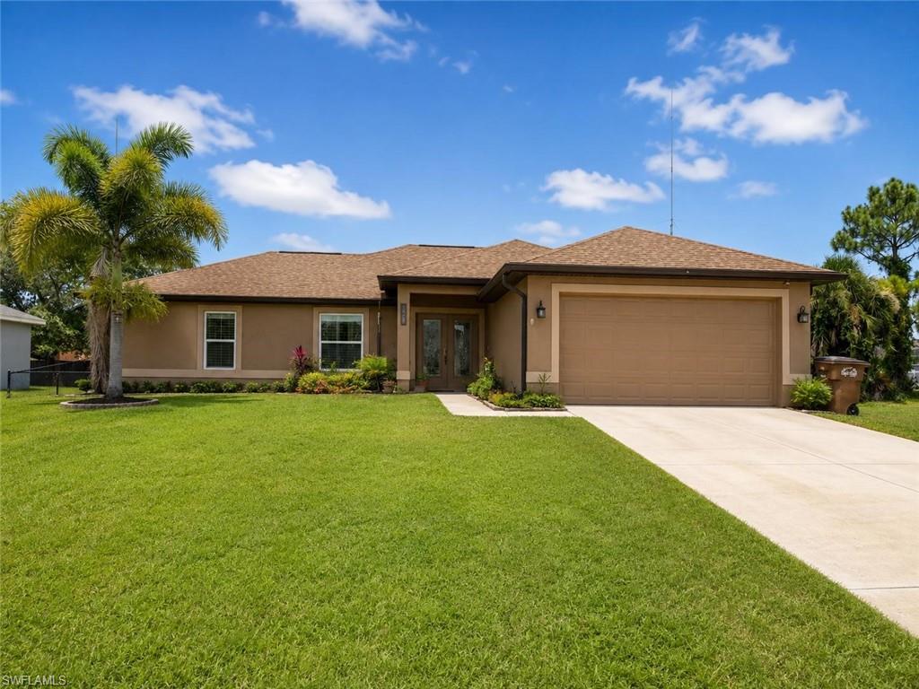 Spacious single-story home featuring a stucco exterior with a gabled roofline and multiple windows