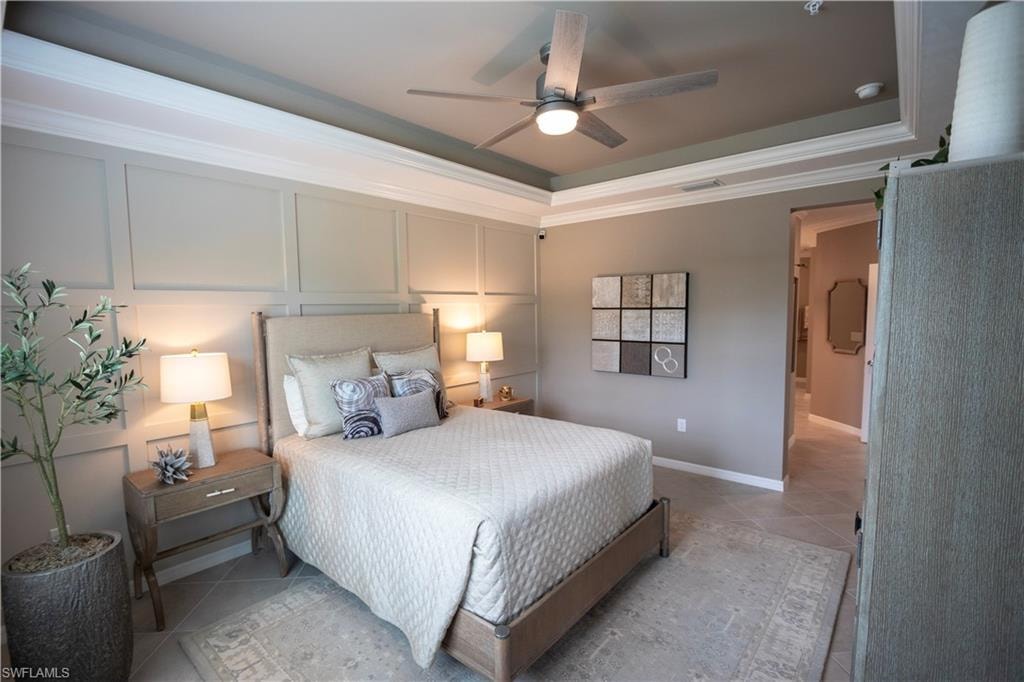 Serene primary bedroom showcasing a coffered tray ceiling with recessed lighting and ceiling fan, soft neutral wall paneling, dual nightstands with integrated table lamps, and plush bedding