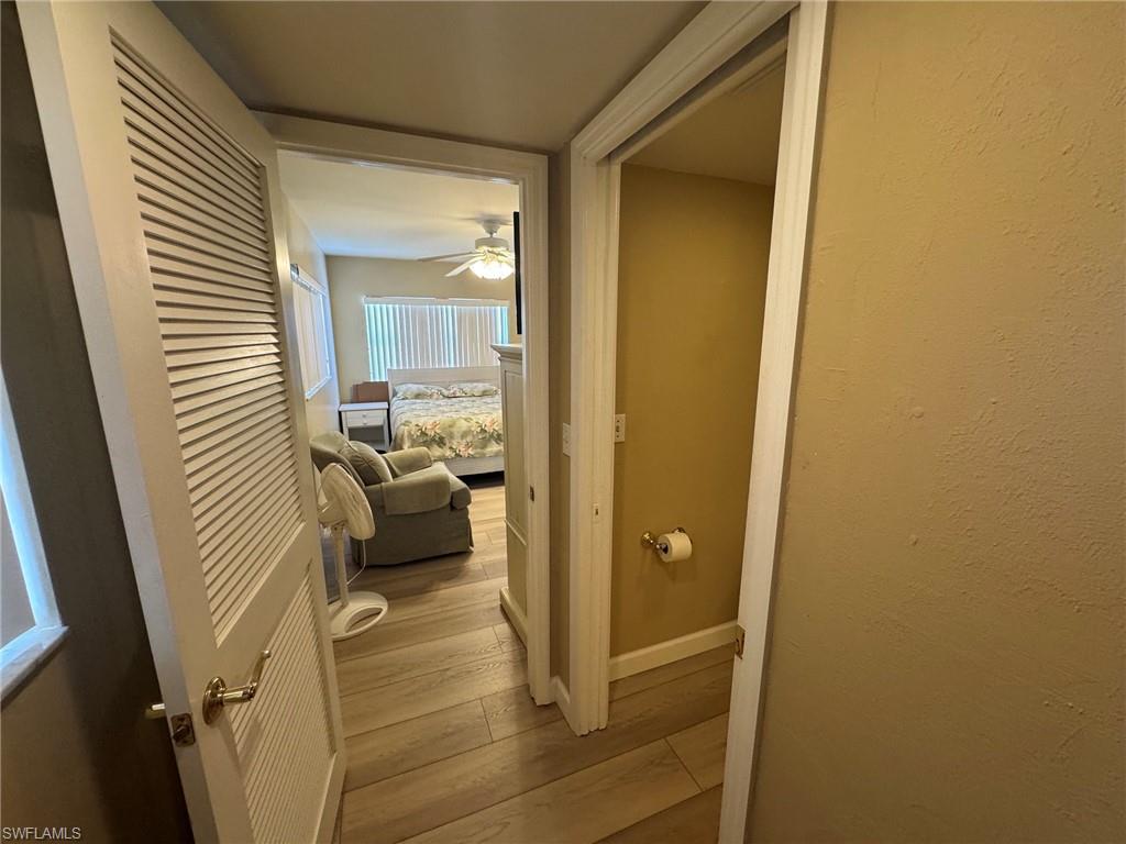 Wood-finish tile flooring throughout, complemented by a louvered bifold door