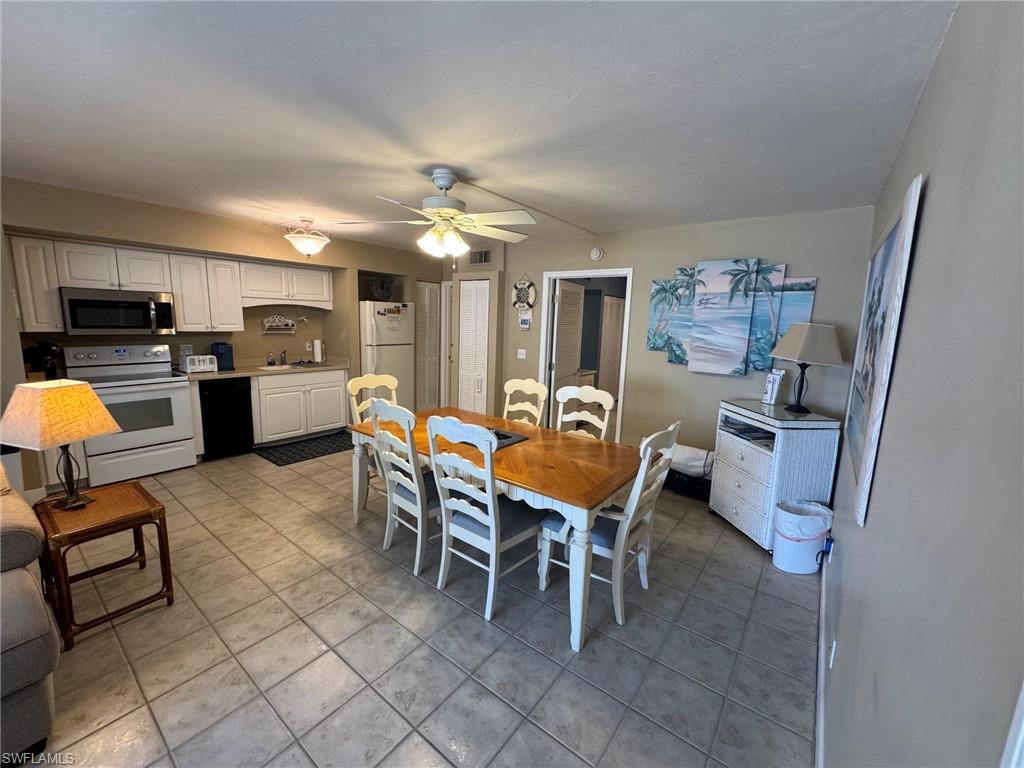 Open-concept kitchen and dining area featuring tile flooring