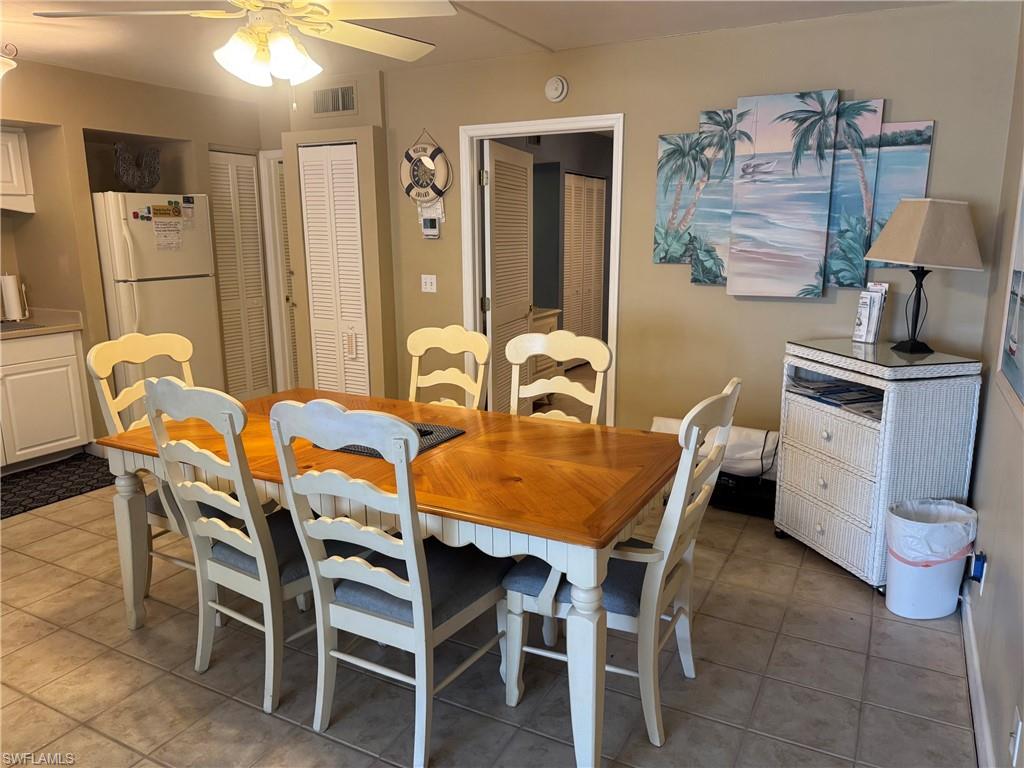 Dining area featuring tiled flooring and a ceiling fan with integrated lighting