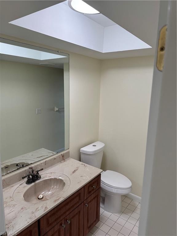 Elegant bathroom featuring a marble-topped vanity with wood-finish cabinetry, a large framed mirror, and polished chrome fixtures