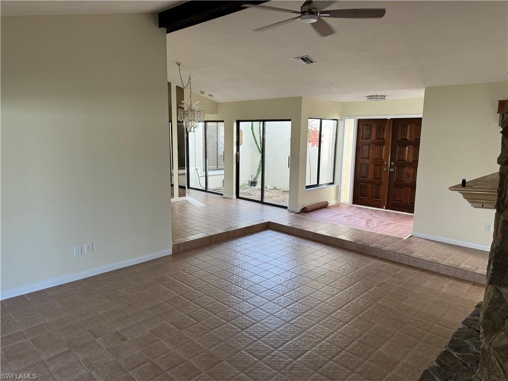Expansive living area with neutral walls and ceramic tile flooring