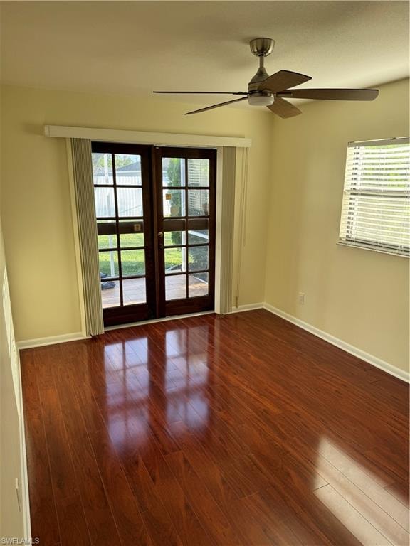 Room featuring wood-finish flooring, a ceiling fan with integrated lighting, and a window with horizontal blinds