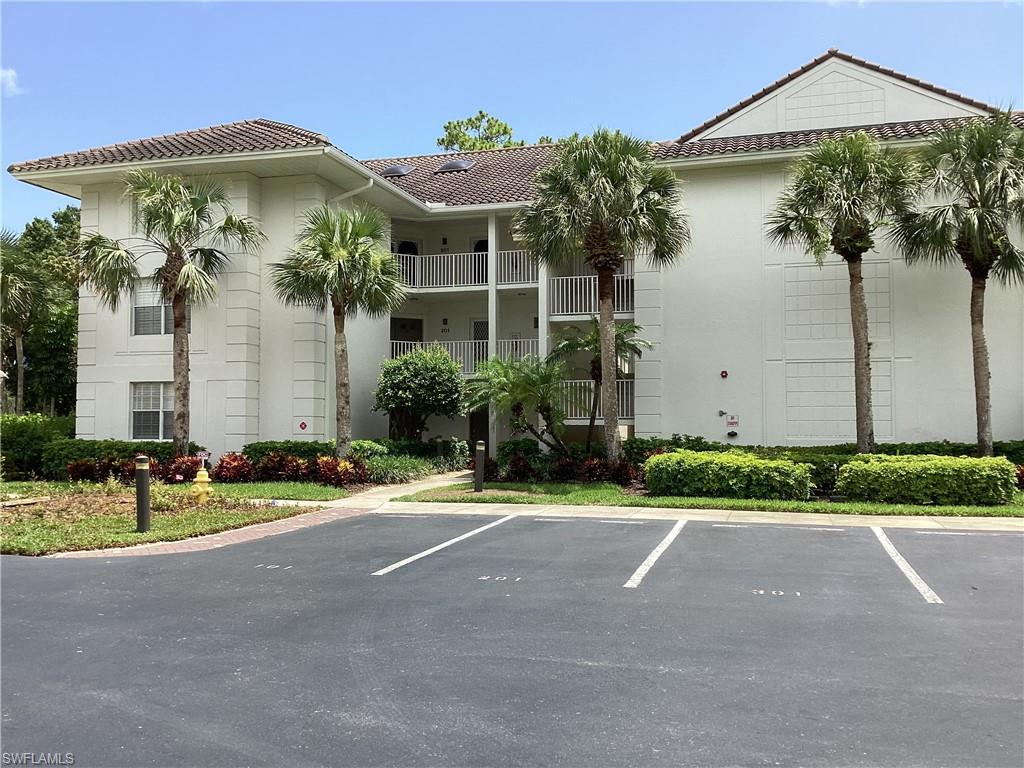 View of building exterior with uncovered parking