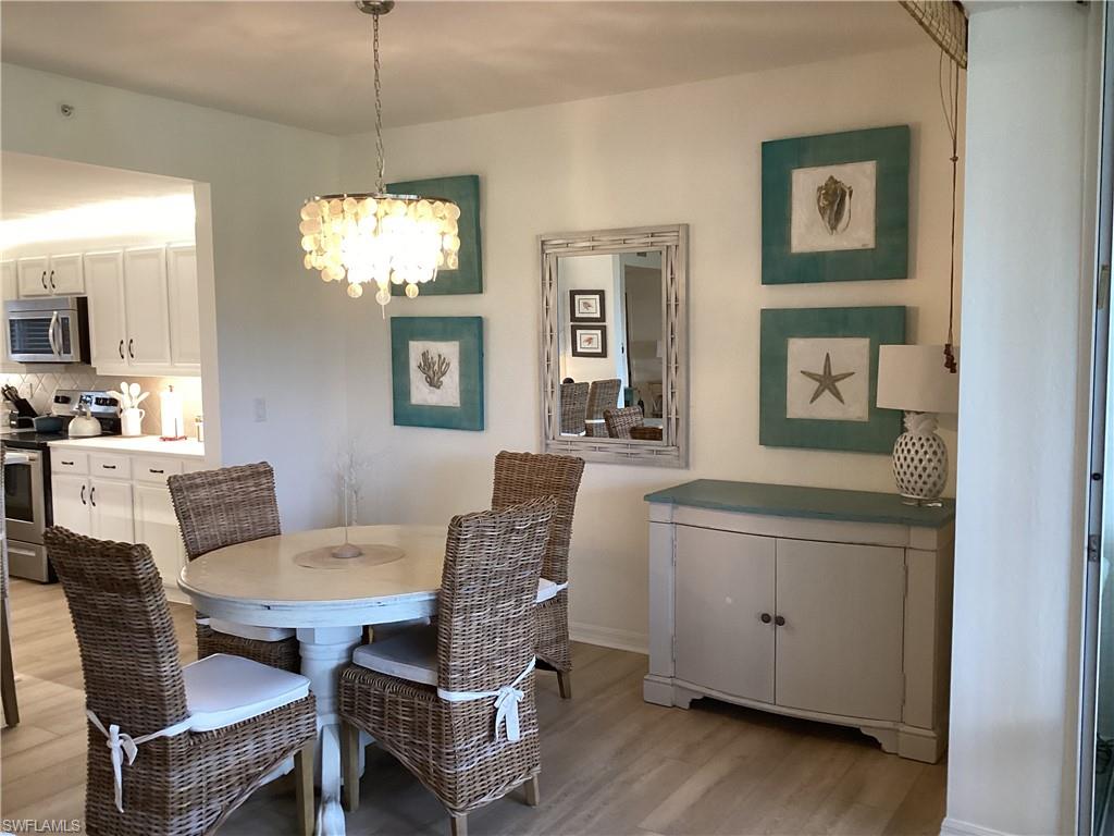 Dining room featuring a chandelier and light wood-style floors