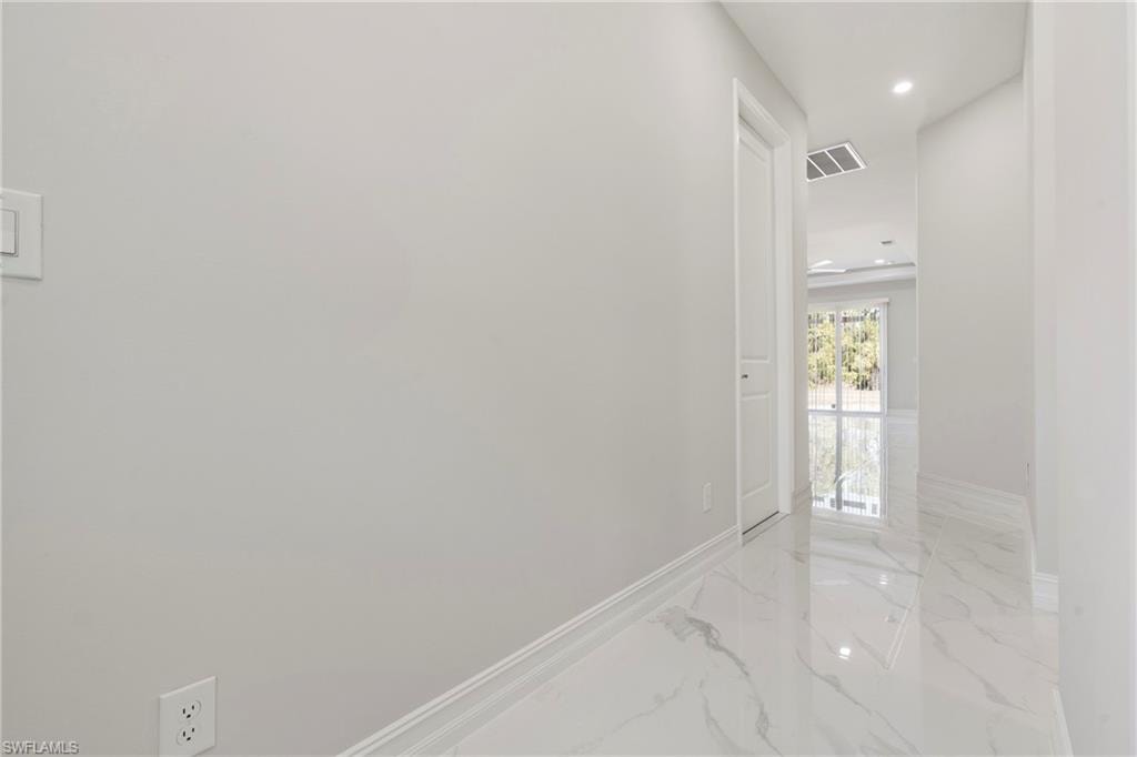 Hall featuring marble finish floor, visible vents, baseboards, and recessed lighting
