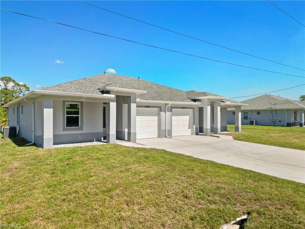 View of front of property with central AC unit, an attached garage, driveway, stucco siding, and a front lawn