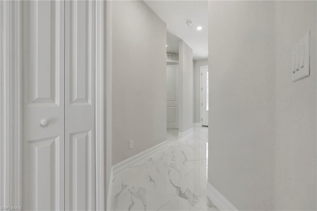 Hall featuring marble finish floor, visible vents, and baseboards