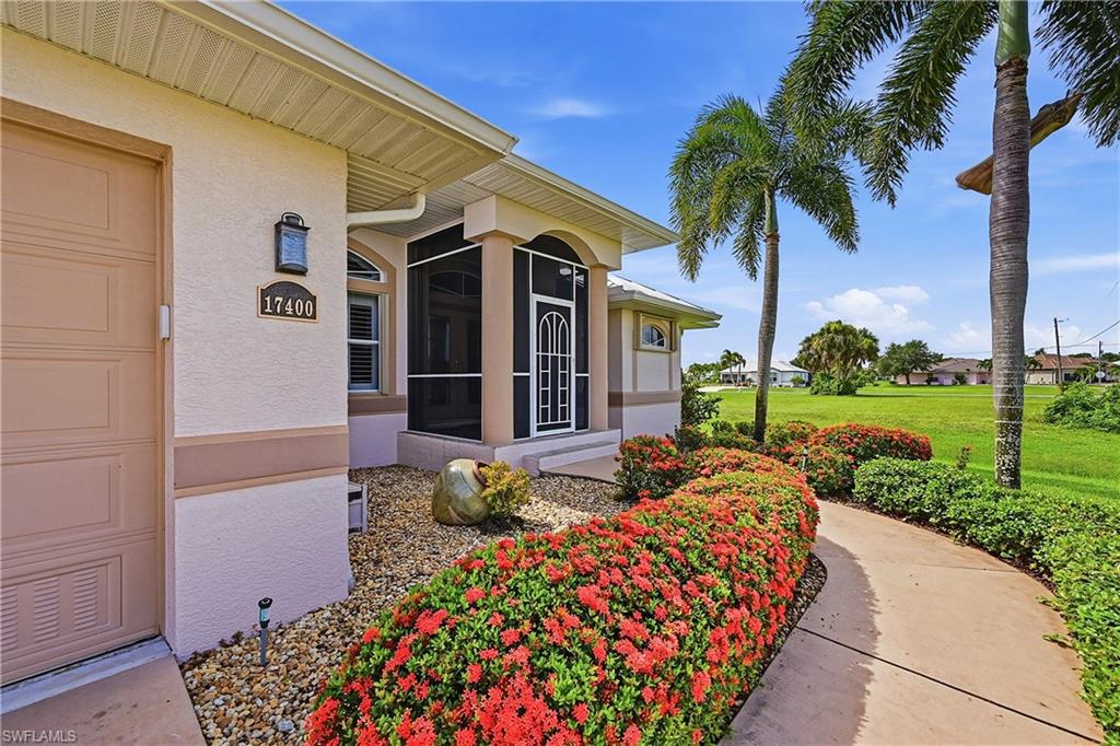 Decorative hedge-trimmed sidewalk from driveway to front entrance