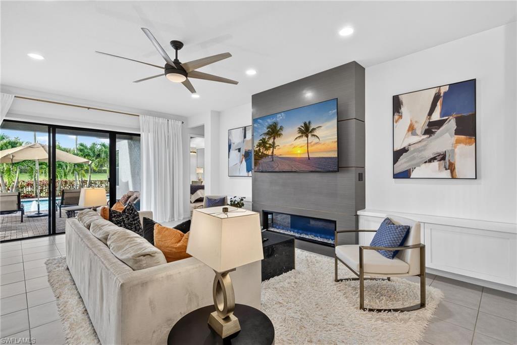Recessed lighting, ceiling fan,  built-in electric fireplace, and tiled flooring