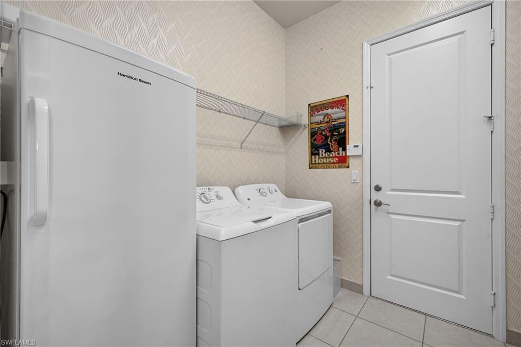 Large 1st floor laundry room, with storage, refrigerator, laundry chute from 2nd floor