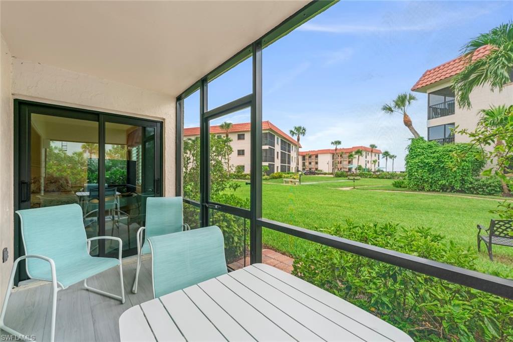 Screened lanai featuring wood-finish flooring and direct access to interior spaces via sliding glass doors