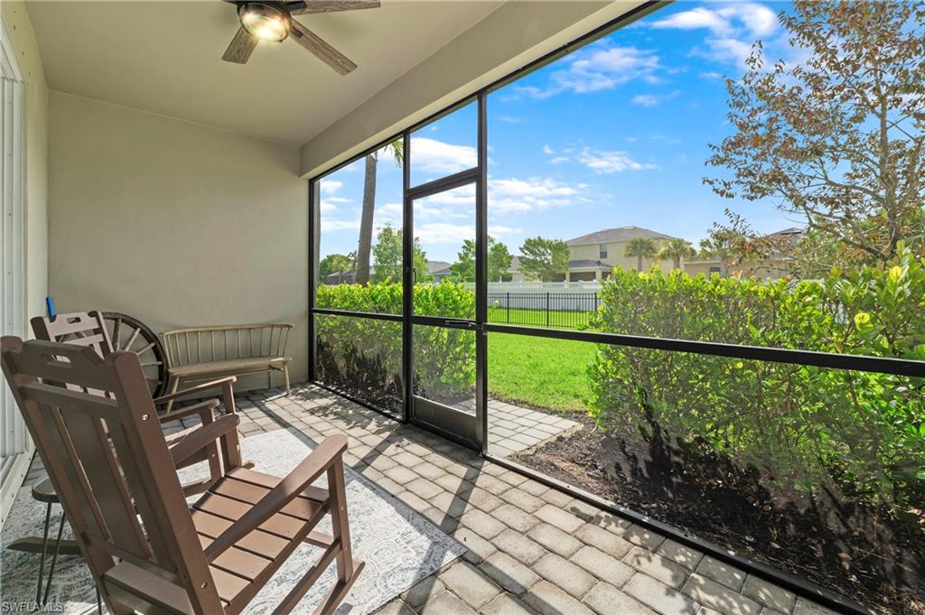 Screened lanai featuring paver flooring and a ceiling fan with integrated lighting
