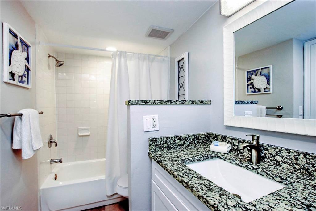 BATH 3 TUB/SHOWER COMBO AND UPDATED CABINETS, FLOORING AND OVERSIZED MIRROR.
