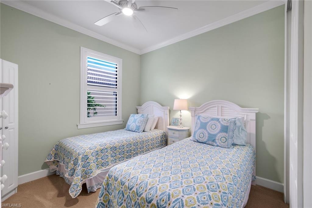 Recessed window with plantation shutters, ceiling fan with integrated lighting, and crown molding