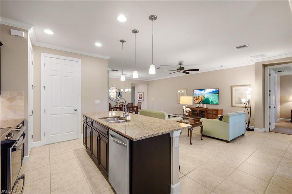 Kitchen island with a light-toned countertop, integrated double sink, and dishwasher