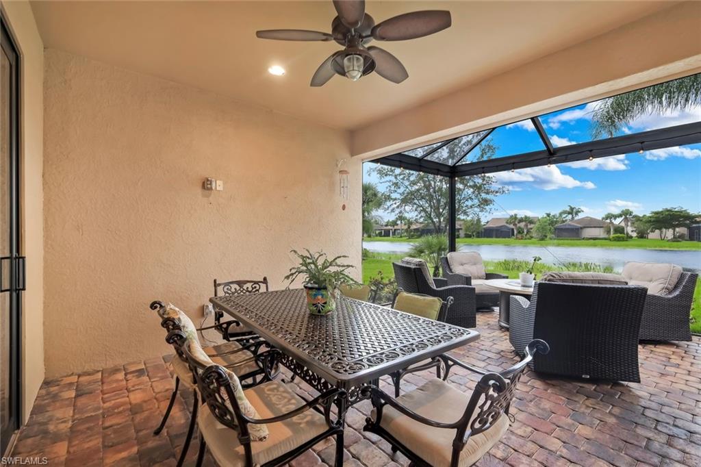 Screened patio with brick paver flooring, overhead ceiling fan, recessed lighting, and water frontage