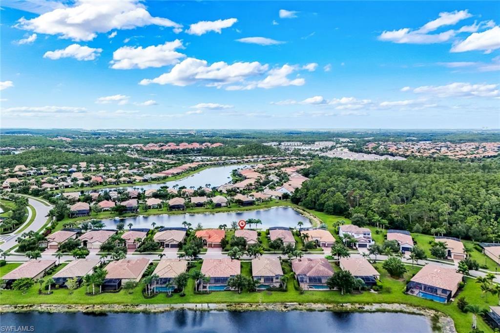 Community setting with residential properties, multiple bodies of water, and surrounding natural areas