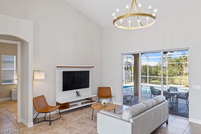 Bright and open living room anchored by a built-in media wall with integrated television and floating cabinetry