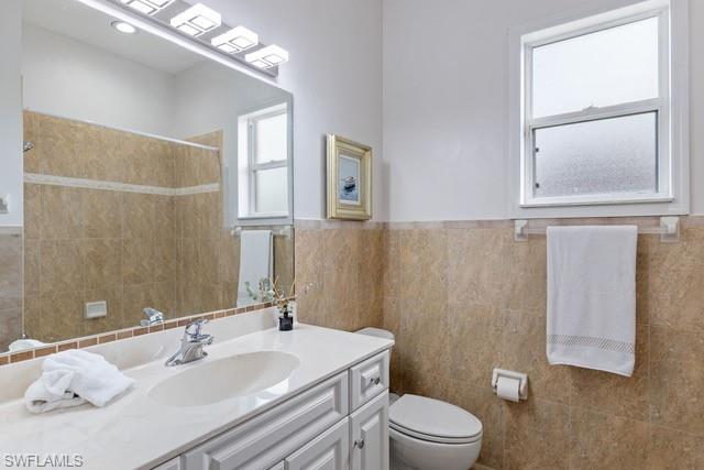 Spa-inspired bathroom featuring a white ceramic vessel sink, polished chrome faucet, and light-filled vanity with ample storage cabinetry