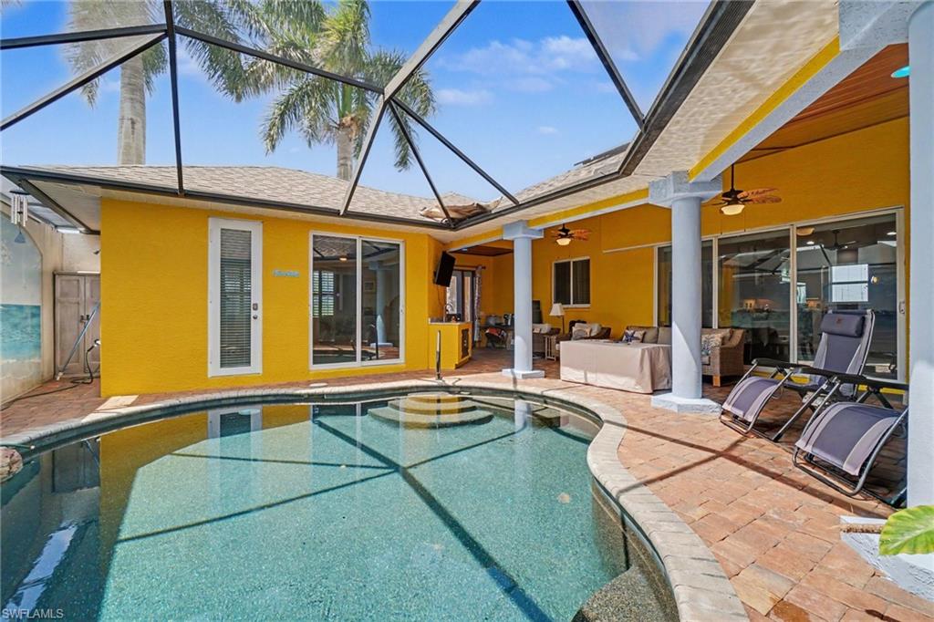 Screened-in outdoor pool featuring a curved design and integrated steps