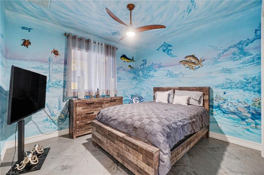 Room featuring custom underwater-themed wall and ceiling murals