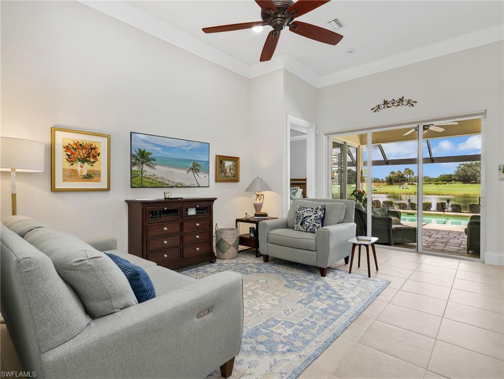 Slider glass doors look out to the pool area the lake in the golf course