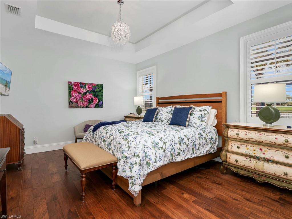 Primary bedroom with which floors and Tracy Primary bedroom with which floors and Trey ceiling