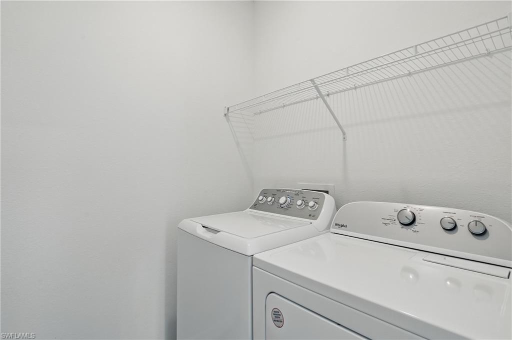 Dedicated laundry area featuring a white wire shelving unit