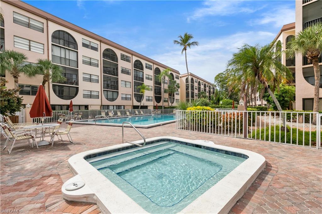 View of pool with a patio and a community hot tub