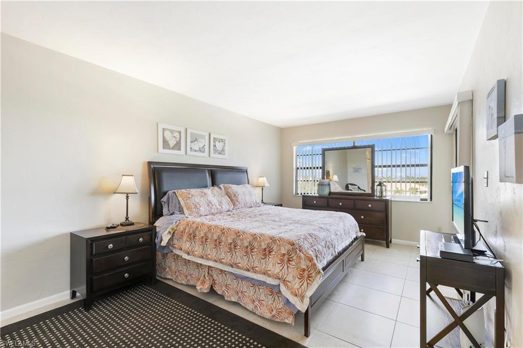 Bedroom with light tile floors