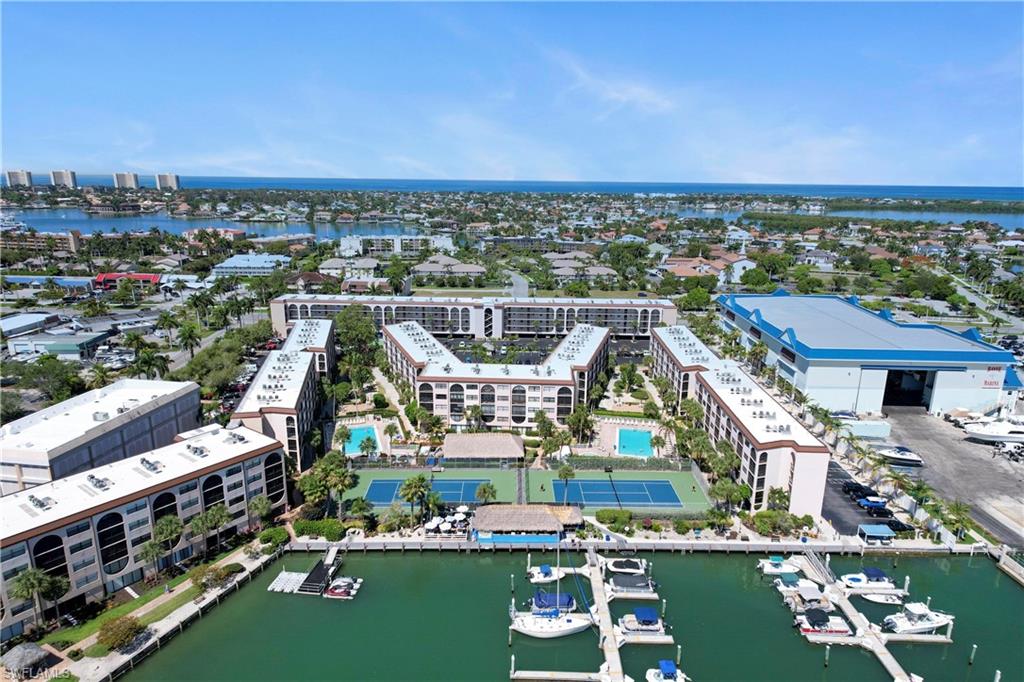 Birds eye view of property with a water view