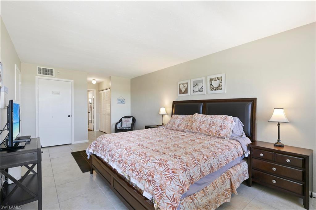 Tiled bedroom featuring a closet