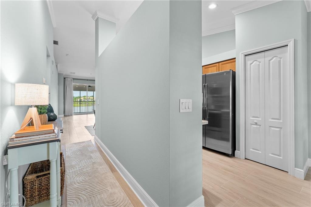 Hallway to main living area. Open to the right for kitchen and breakfast nook, view of pantry doors.