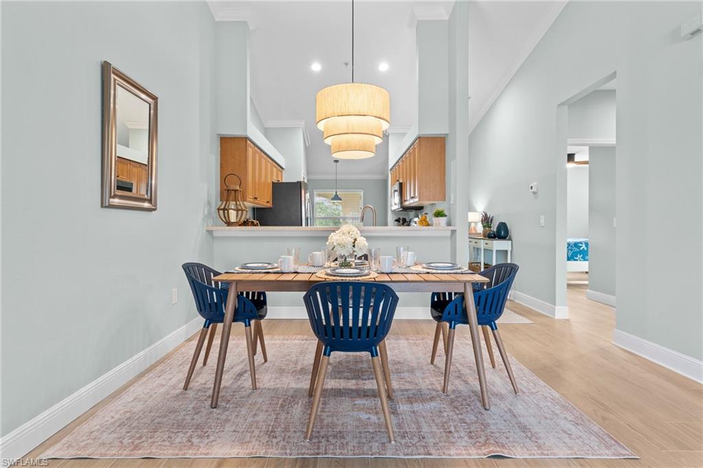 Dining / Living area - Open floor plan. SW sea salt paint throughout, tile plank floors throughout, beautiful cathedral ceilings. Opening is to guest bedroom, guest bath, laundry room.
