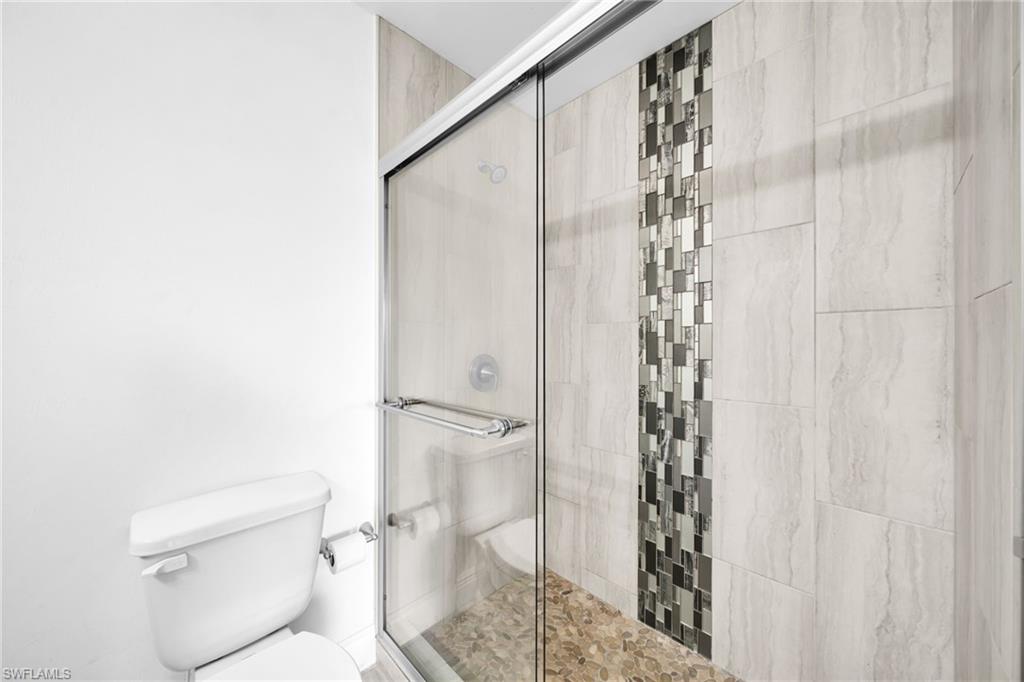 Shower enclosure featuring clear glass sliding doors and polished chrome hardware