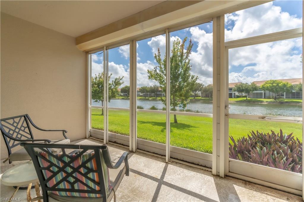 Screened porch with concrete flooring, offering expansive water and landscaped green space