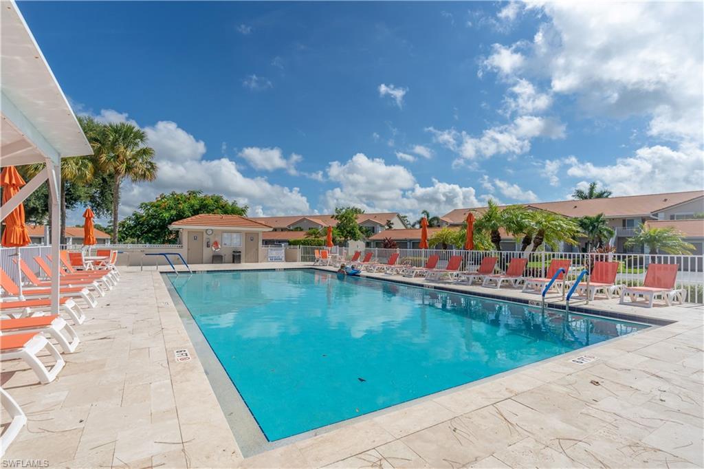 Rectangular swimming pool with a light blue interior, surrounded by a light-toned paver deck