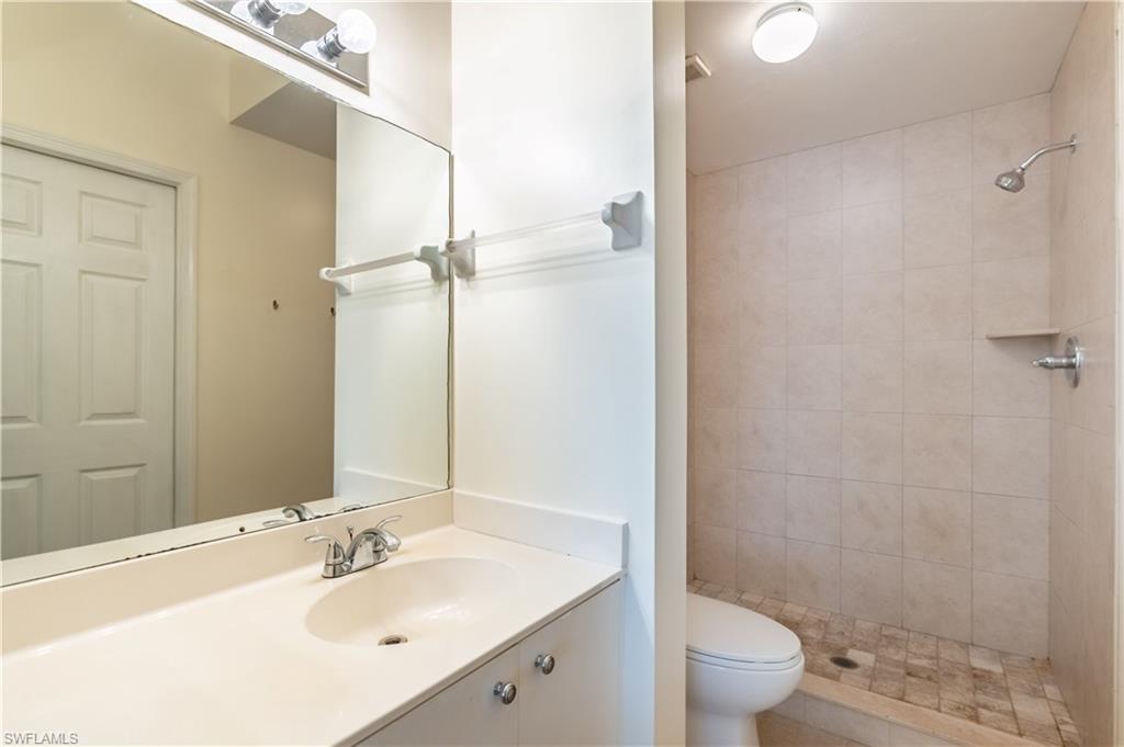 Bathroom featuring a vanity with an integrated sink, polished chrome faucet, and a large wall-mounted mirror