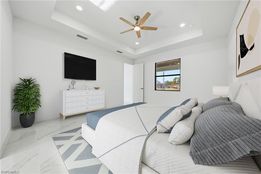 Tray ceiling with recessed lighting, ceiling fan, white walls, and large window