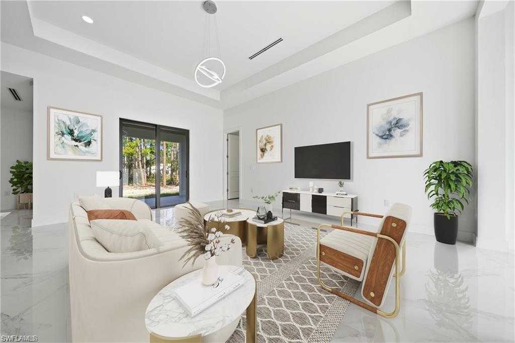 Spacious living area featuring high ceilings, large format tile flooring, a contemporary pendant light fixture, and sliding glass doors